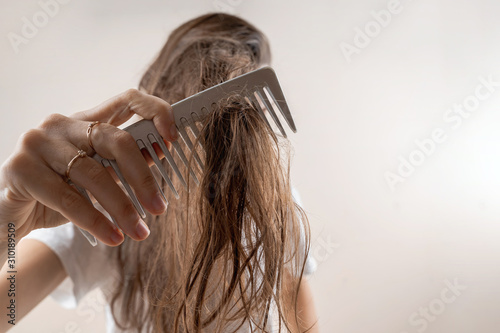 Beautiful caucasian woman girl with wet messy hard after bath. Thin hair problem. Isolated photo