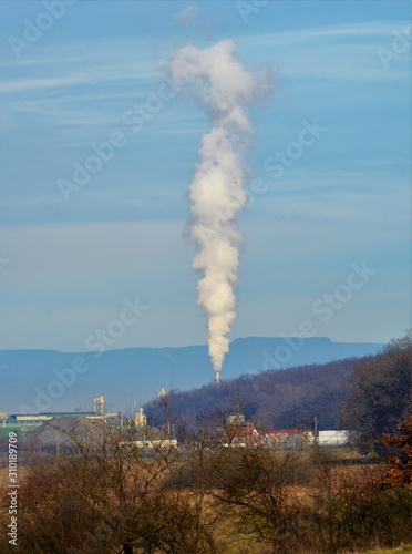 white smoke coming out of the chimney of a factory