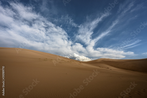 Large Cloud Rises Over Sand Dunes