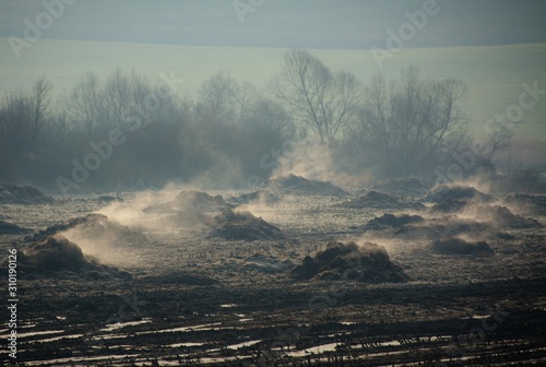 steam coming out of piles of garbage photo