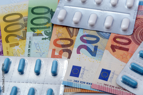 drug and medicine tablets with euro banknotes money