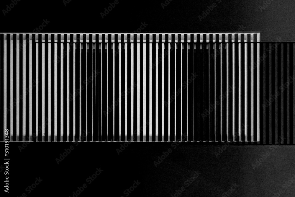 Lath structures as pattern with irregular or gently chaotic stripes resembling bar code or business architecture fragment. Abstract geometric template against black background. Lath structures as pattern with irregular or gently chaotic stripes resembling bar code or business architecture fragment. Abstract geometric template against black background.