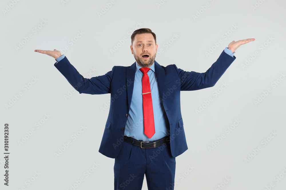 Portrait of emotional mature man on light grey background Portrait of emotional mature man on light grey background