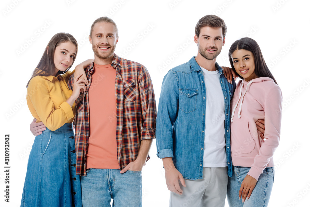 happy multicultural couples embracing isolated on white