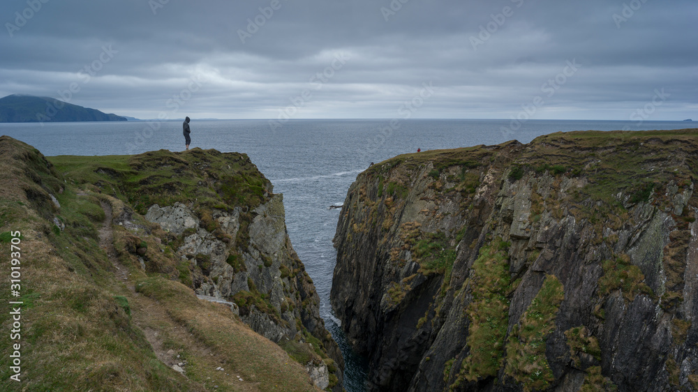 Person standing on cliff, Achill Island, County Mayo, Ireland Person standing on cliff, Achill Island, County Mayo, Ireland