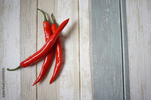 Top view of red hot chili pepper over vintage background.