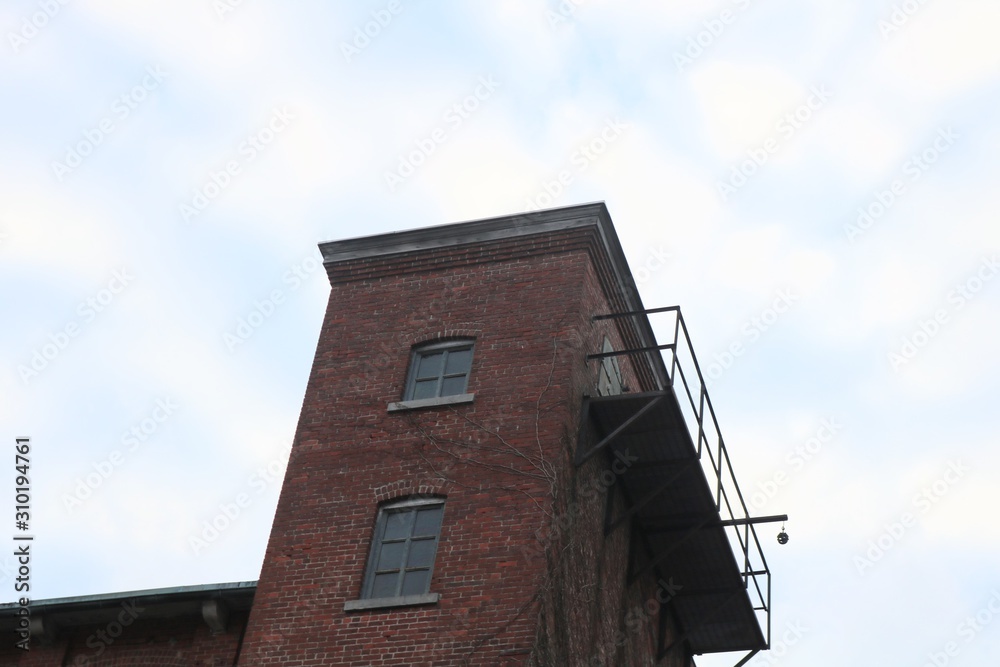 Old abandoned brick factory clock tower industrial vacant building with clock 