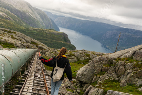 Woman in retro clothing walking down the 4444 stairs of Flørli. Located in Lysefjorden, Norway