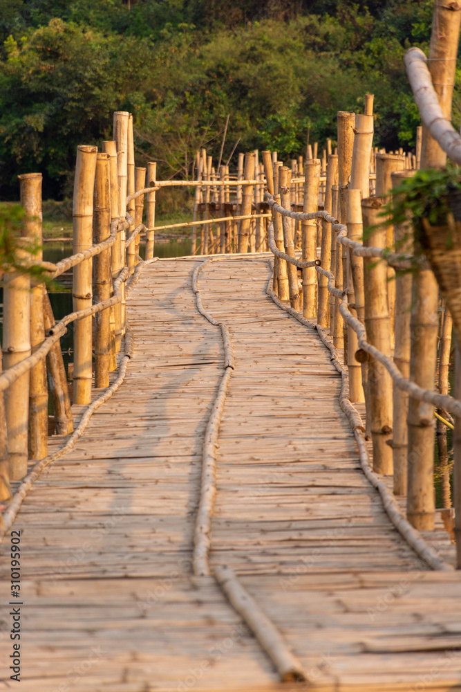 Fototapeta Bamboo bridge over to the forest