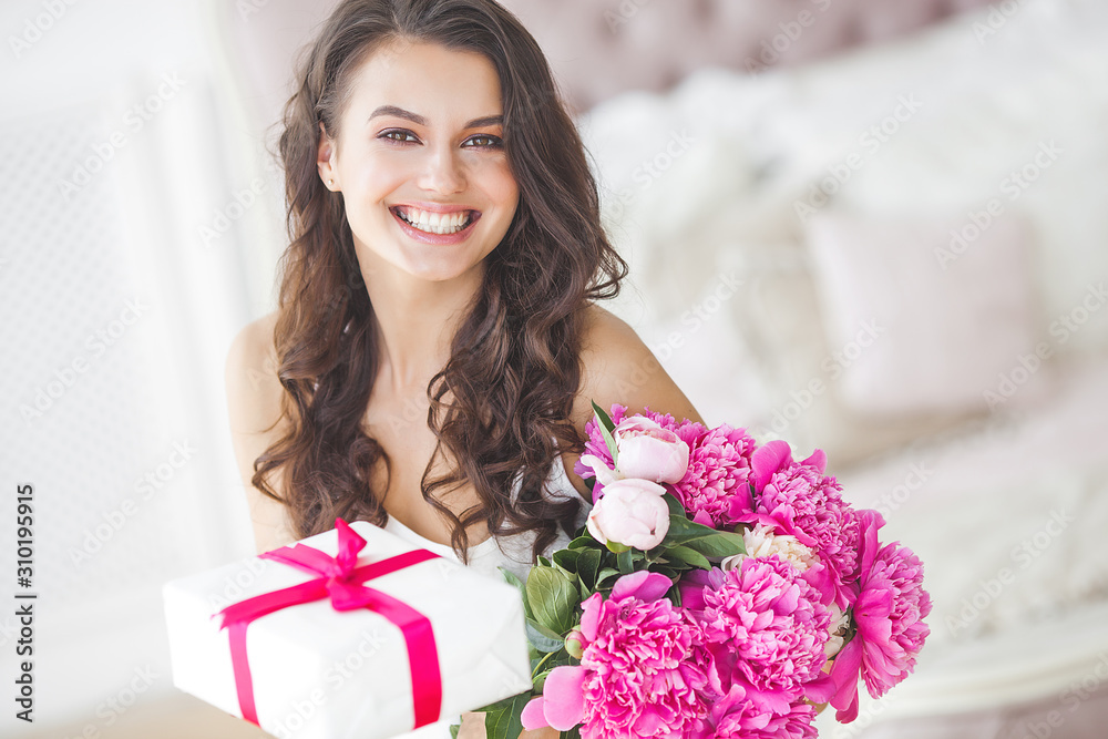 Very beautiful woman with peony and gift box indoors Very beautiful woman with peony and gift box indoors