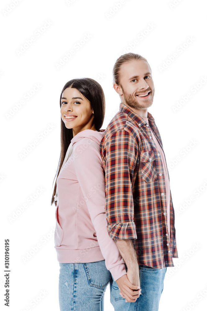 happy young interracial couple standing back to back and holding hands isolated on white happy young interracial couple standing back to back and holding hands isolated on white