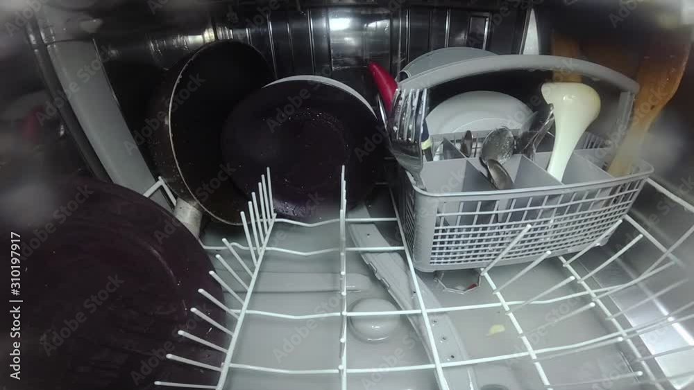 Slow motion. The master repairs the dishwasher and checks the operation