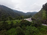 Scenic aerial view of “Lebuhraya Utara-Selatan”, a highway located in Malaysia. Highway surrounded by forest, winding road