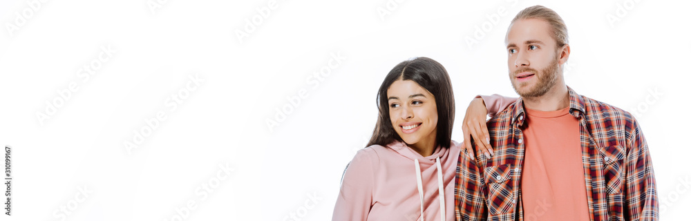 happy young interracial couple looking away isolated on white, panoramic shot happy young interracial couple looking away isolated on white, panoramic shot