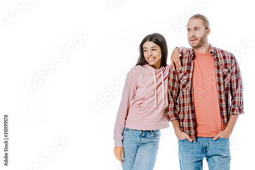 happy young interracial couple looking away isolated on white