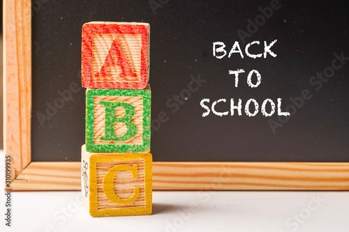 Back to School wordings on chalkboard with alphabet cubes