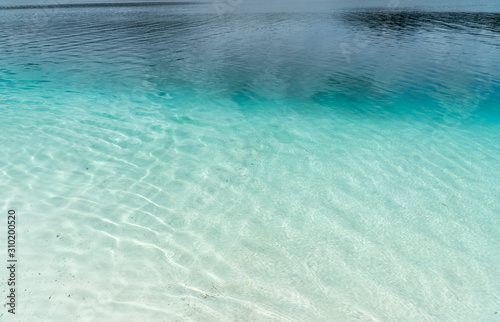 the turquoise blue water of a lake on Fraser Island in Australia