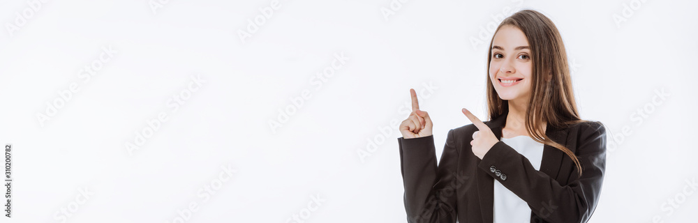 smiling businesswoman in suit pointing with fingers up isolated on white, panoramic shot smiling businesswoman in suit pointing with fingers up isolated on white, panoramic shot