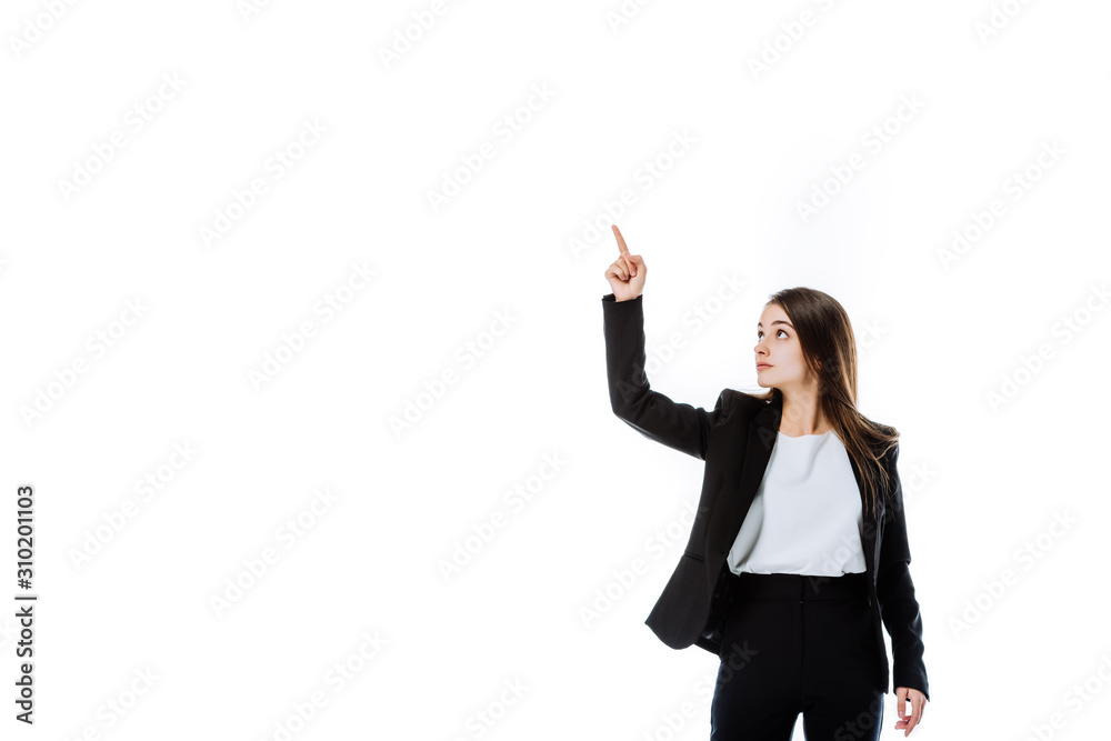 confident businesswoman in suit pointing with finger upwards isolated on white confident businesswoman in suit pointing with finger upwards isolated on white