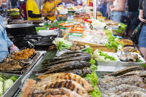 street foods of Thailand, foods style Grilled seafood feast for the party at night market Bangkok of Thailand