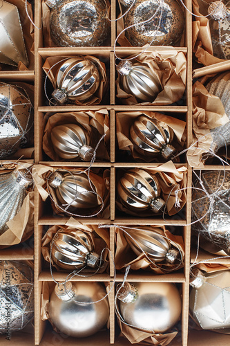 Set of Luxury Silver Glass Baubles. Retro styled image of vintage Christmas decoration in a box. Christmas holidays composition.