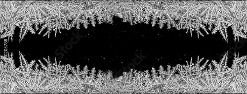 Slika na platnu Decorative ice crystals on a window in form of a frame on black matte background