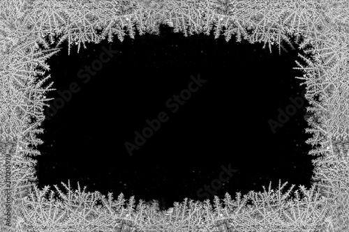 Canvastavla Decorative ice crystals on a window in form of a frame on black matte background
