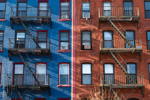 Old Blue and Red Brick Buildings in the East Village of New York City with Fire Escapes photo