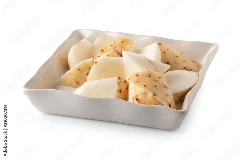 Yamaimo roots and slices or Chinese yam isolated over white background