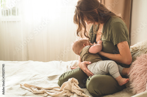 The concept of breastfeeding. Portrait of mom and breastfeeding baby. 