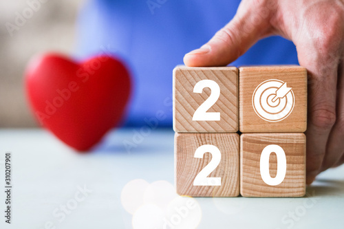 Wallpaper Mural Hand holding wood block with New year 2020 and goal progress icon in healthcare. Torontodigital.ca