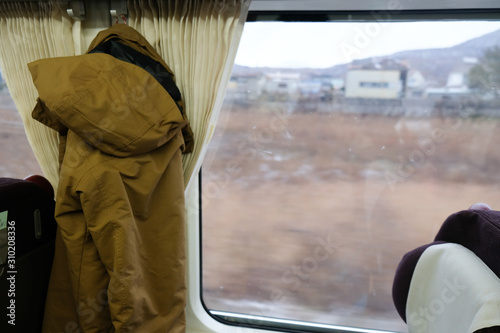 Looking through window with snow travels on a train in Hokkaido Japan.