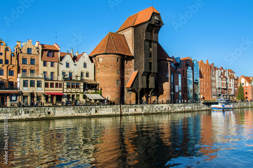 Famous historic Medieval port Crane (Żuraw / Krantor) - one of the Gdańsk water gates. Sunny morning on the Motlava River. Old town Gdansk (Gdańsk / Danzig), Poland