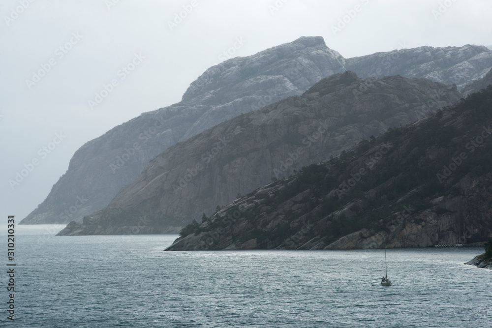 Sail Boat Navigating Through The Norwegian Fjords Sail Boat Navigating Through The Norwegian Fjords