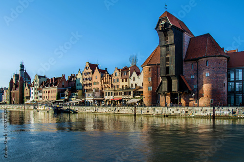 Famous historic Medieval port Crane (Żuraw / Krantor) - one of the Gdańsk water gates. Sunny morning on the Motlava River. Old town Gdansk (Gdańsk / Danzig), Poland