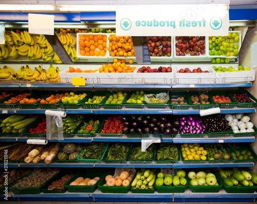 Various vegetables and fruits on display in grocery store
