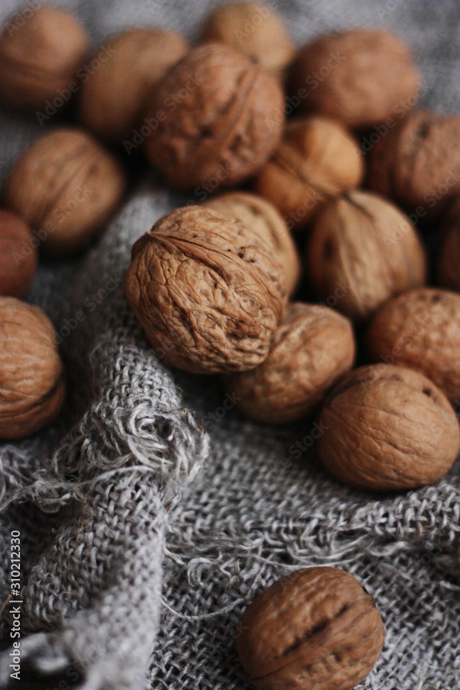 Walnuts on a grey linen background macro Walnuts on a grey linen background macro