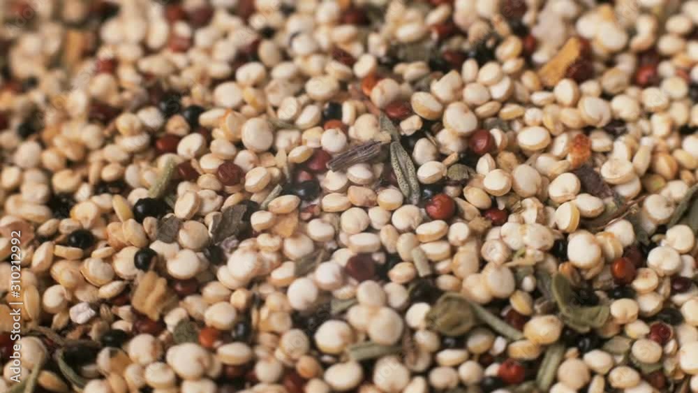 Mixed quinoa vegetarian crop with spices is rotating macro background Mixed quinoa vegetarian crop with spices is rotating macro background