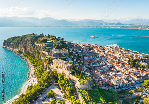 Nafplio city in Greece on green peninsula with small houses view from above at sunset photo