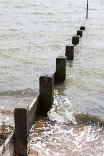 Wave hitting beach Groyne photo