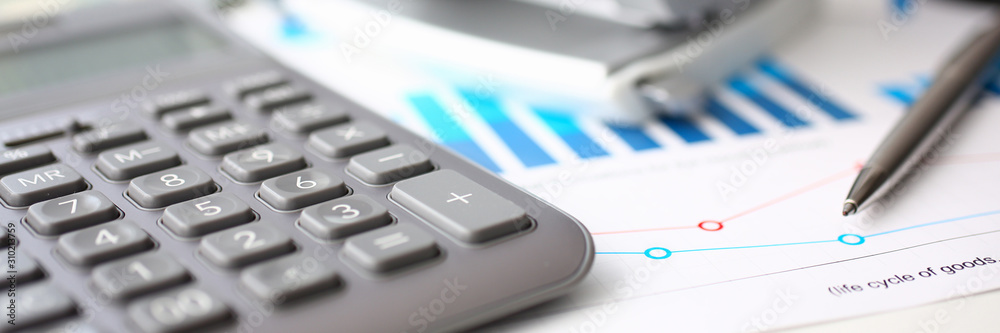 Silver calculator and financial statistics on clipboard Silver calculator and financial statistics on clipboard