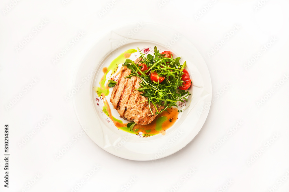 Chicken fillet in a restaurant close-up. Wild duck fillet with vegetables on a white plate and copy space. Chicken fillet in a restaurant close-up. Wild duck fillet with vegetables on a white plate and copy space.
