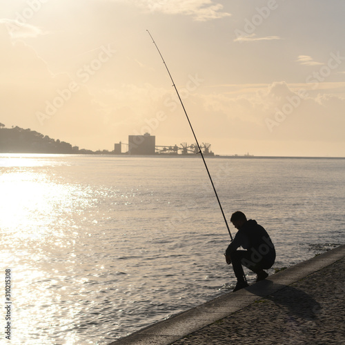 Man fishing in river, Alcantara, Lisbon, Setubal District, Portugal photo