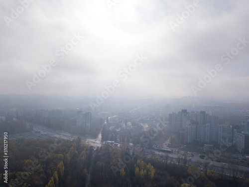 Cityscape with houses on a sunny foggy sky background.