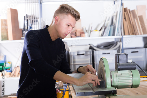 Guy working on grinding machine