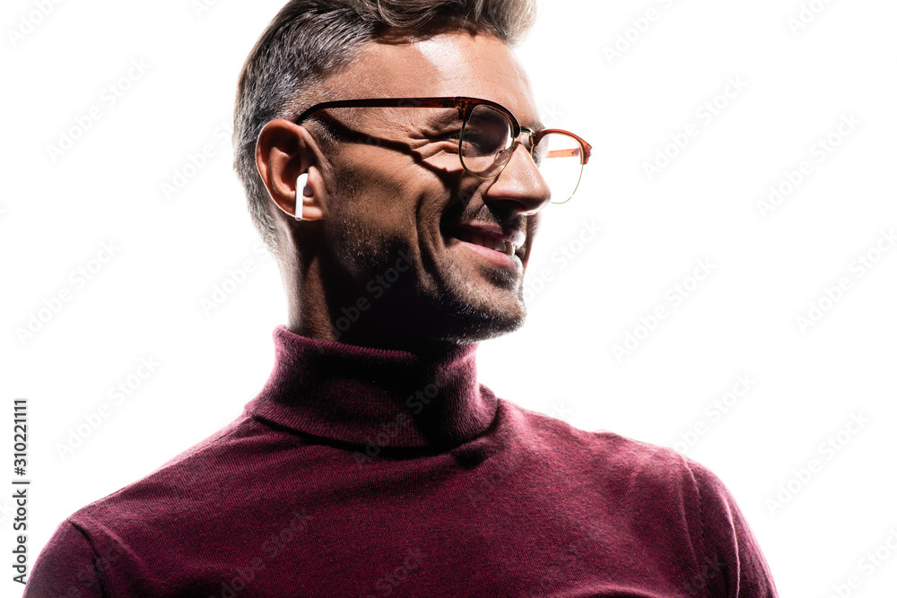 Smiling man in wireless earphones and eyeglasses looking away isolated on white Smiling man in wireless earphones and eyeglasses looking away isolated on white