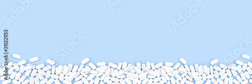 Photos Blue monochrome border of pile of pills tablets on the table