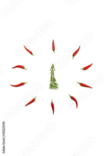 Abstract Christmas background in the form of a clock and a fir tree made of rosemary and chili pepper on a white background. Food concept, Christmas minimalism