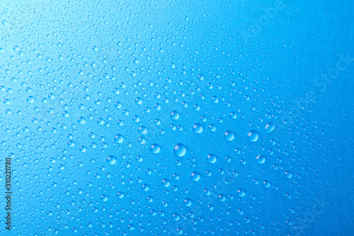 Many water drops on blue background. Texture background, macro