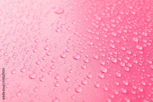 Many water drops on pink background. Texture background.